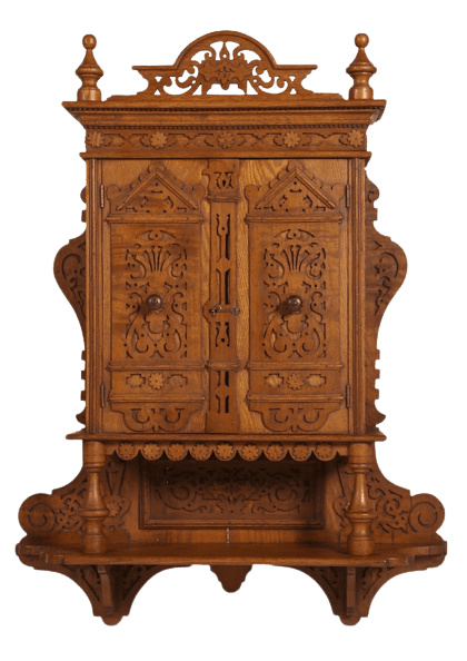 A wooden cabinet with carvings on it.