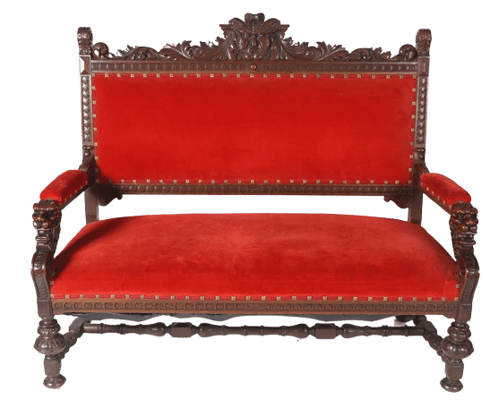 A red couch with an ornate wooden frame.