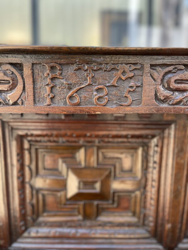A close up of the carved wood on an old desk