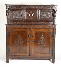 A wooden cabinet with carvings on the front and back.