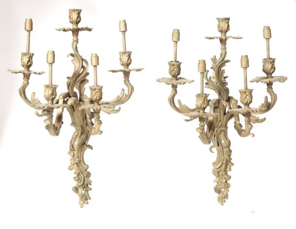 A pair of large wall sconces with gold finish.