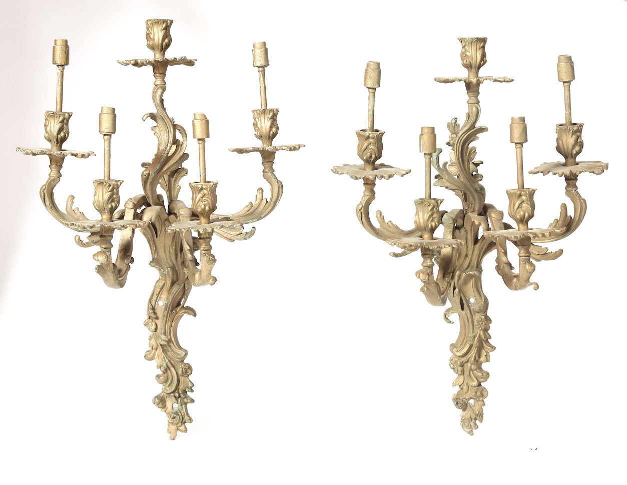 A pair of large wall sconces with gold finish.