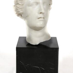 A marble bust of a woman on top of a black stand.