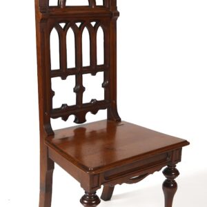 A wooden chair with an ornate back and seat.