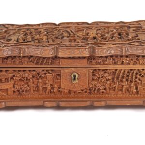 A wooden box with carvings on it.