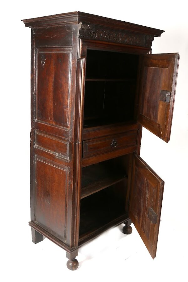 A large wooden cabinet with two doors and one drawer.