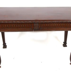 A wooden table with two drawers and carved legs.