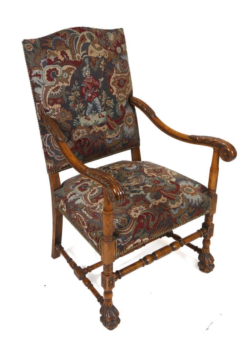A chair with floral fabric and wooden arms.