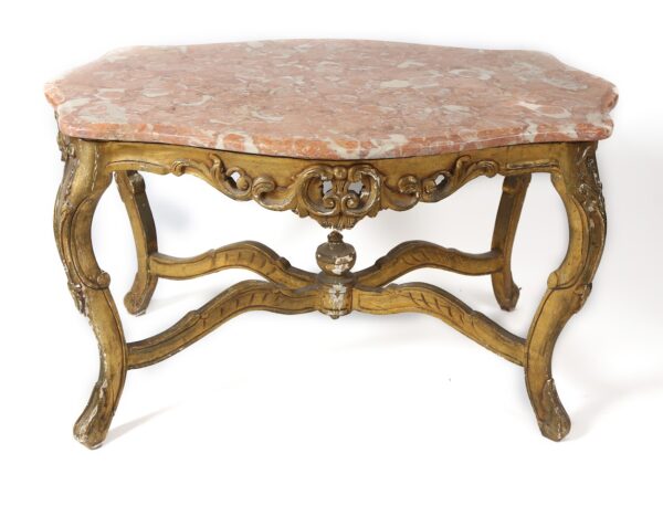 A marble top table with gold colored legs.