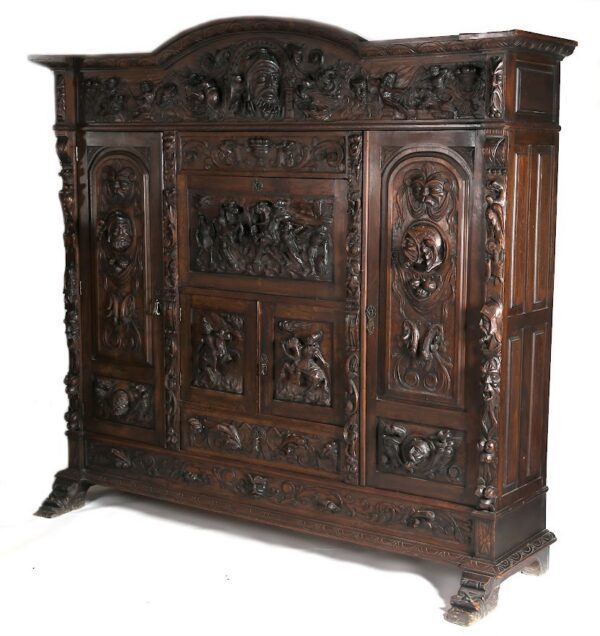 A large wooden cabinet with carvings on the front and sides.