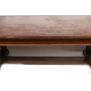 A wooden table with two legs and a brown top.