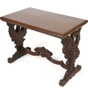 A wooden table with carved legs and a brown top.