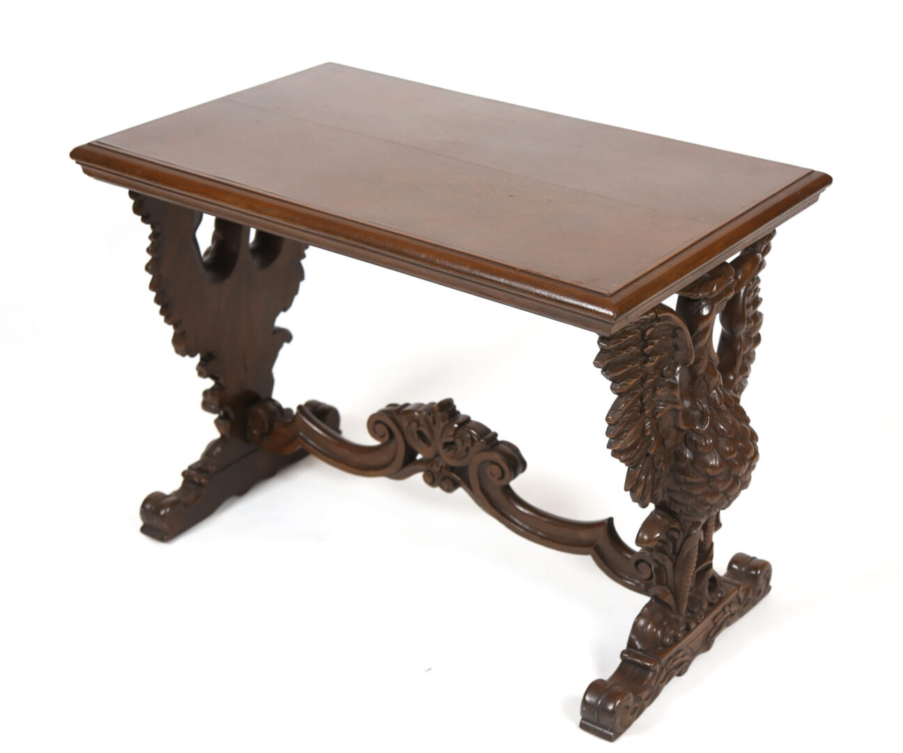 A wooden table with carved legs and a brown top.