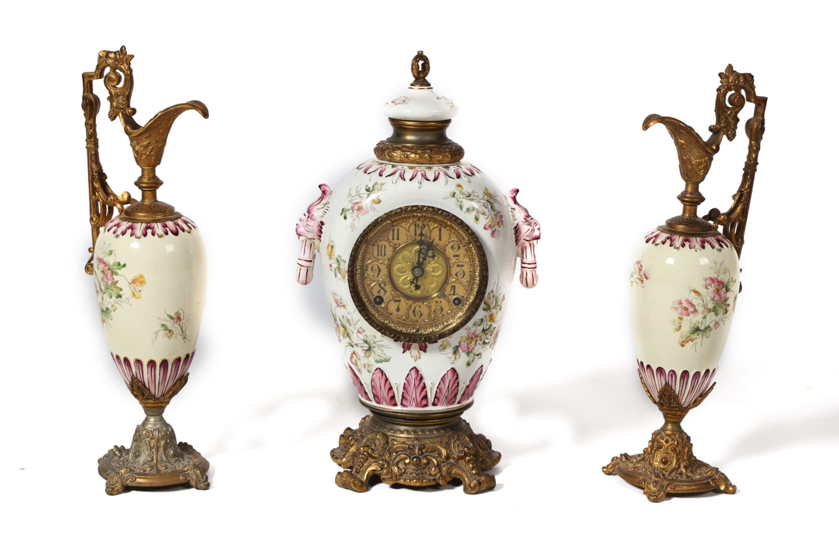 A set of three vases with a clock on top.