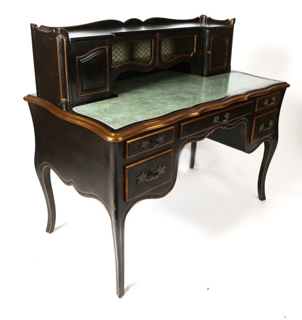 A desk with two drawers and a large green top.