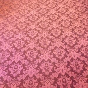 A pink carpet with a pattern of flowers.