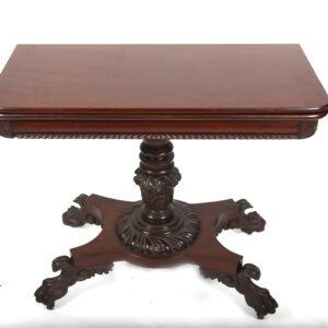 A table with a wooden top and a carved pedestal.