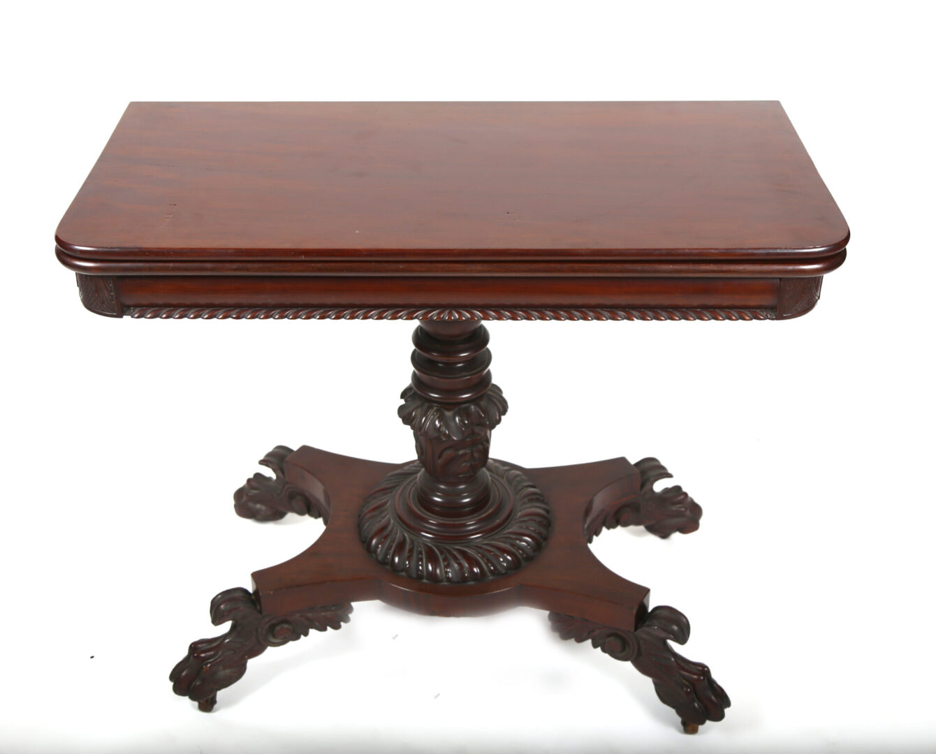 A table with a wooden top and a carved pedestal.