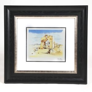 A framed painting of a man and woman in the desert.