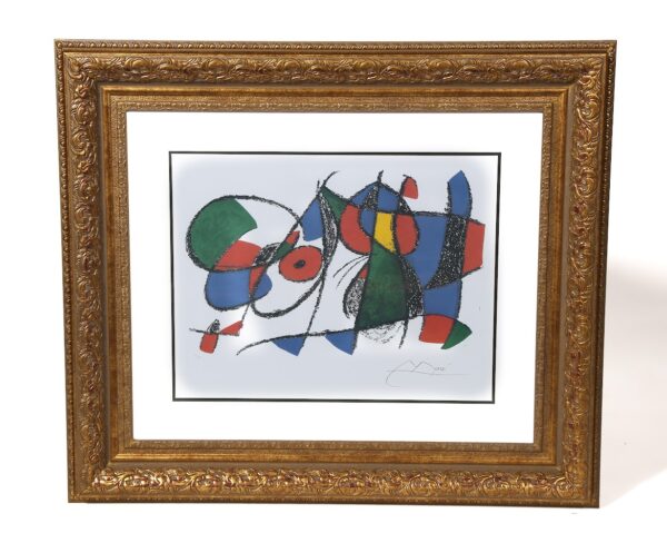 A painting of colorful shapes and lines in a gold frame.
