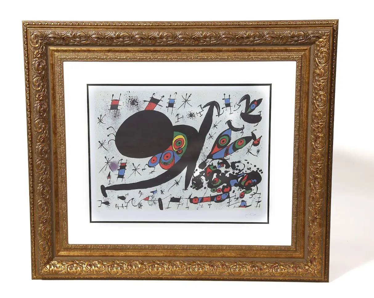 A framed painting of an abstract design.