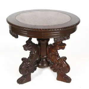 A round table with two carved dogs on top of it.