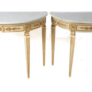 A pair of painted and gilded consoles with marble tops.