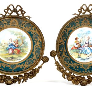 A pair of antique french porcelain plaques with bronze frames