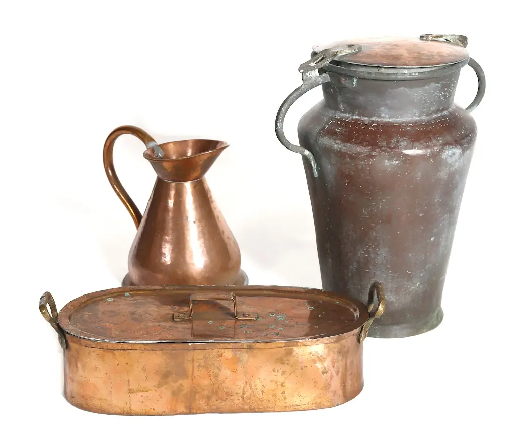 A group of three copper containers and a pitcher.