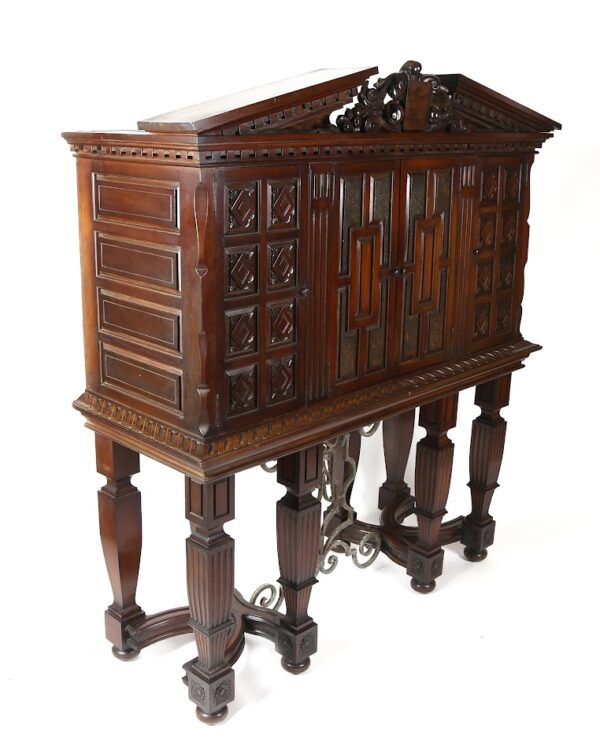 A large wooden cabinet on stand with ornate carvings.