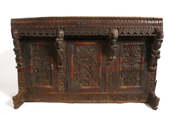 Ornate carved wooden cabinet with doors.