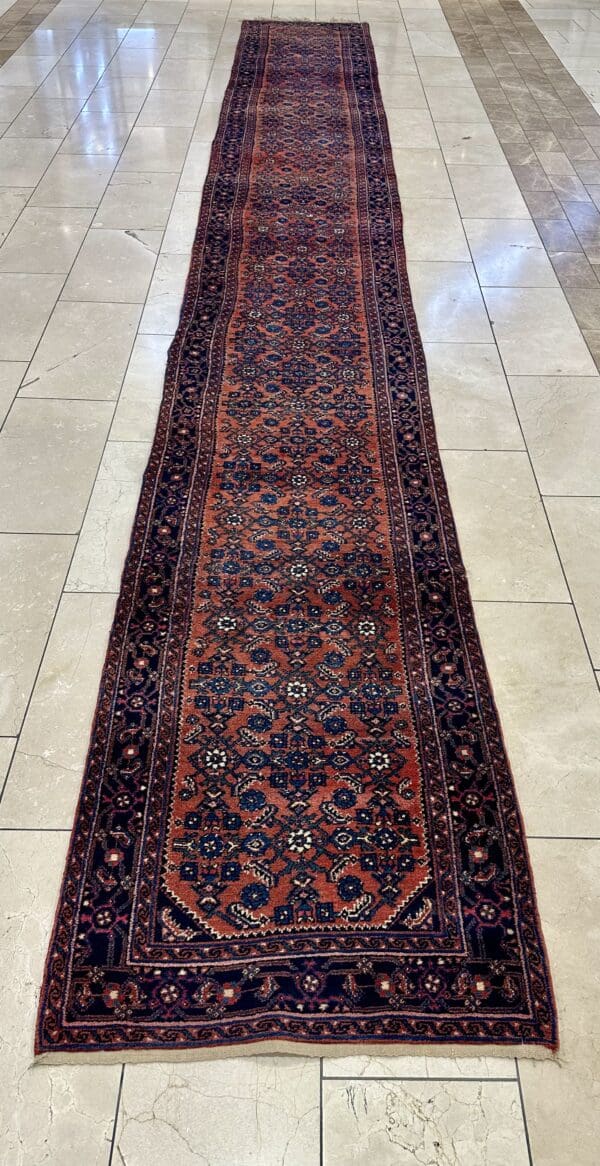 Long Persian rug with floral pattern.