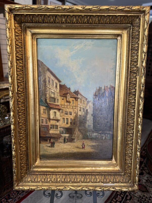 Framed oil painting of European street scene.