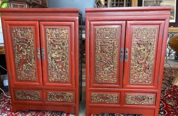 Two ornate red Chinese cabinets with gold accents.