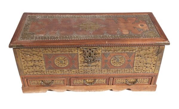 Ornate wooden chest with brass inlay.