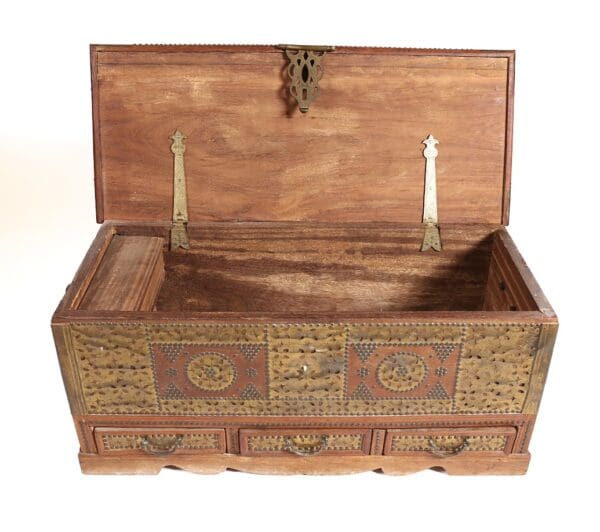 Ornate wooden chest with brass inlay.