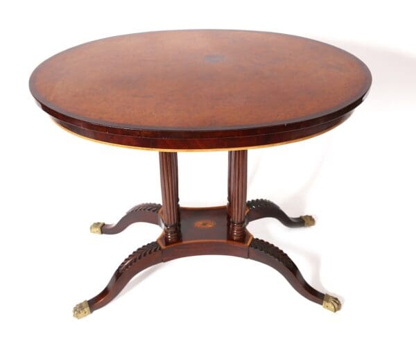 Oval wood table with carved legs.