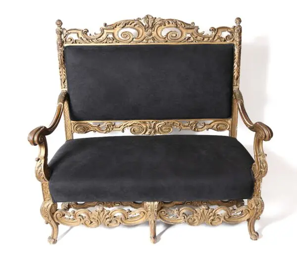 Ornate gold-trimmed black velvet settee.