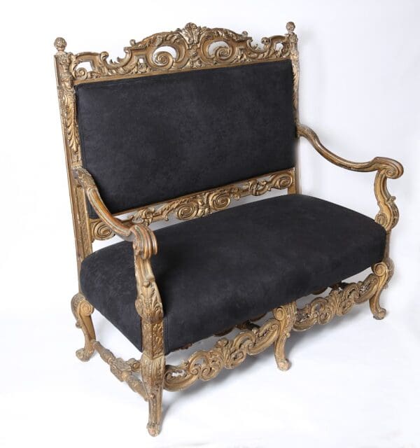 Ornate gold and black two-seater sofa.