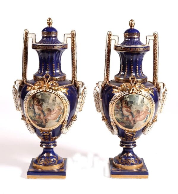 Pair of large Antique Serves Urns hand painted porcelain fronts and backs depicting cherubs at play