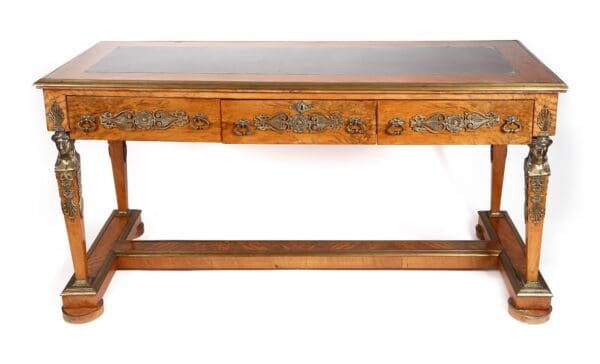 Antique wooden writing desk with brass details.