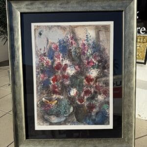 Framed abstract painting with colorful flowers displayed.