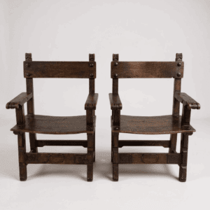 Two vintage wooden chairs side by side.