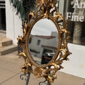 Antique French hand-carved giltwood oval mirror