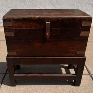 Charming Antique English chest with brass detailing on wooden stand
