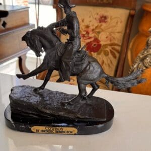 Bronze on marble base after Frederic Remington entitled “Cowboy”