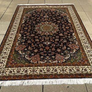 New Persian Silk Qum carpet, 9'10" x 6'5", hand-finished with a deep midnight-blue field, intricate central medallion and contrasting ivory border at The Chapman Collection