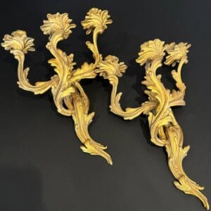 Pair of antique French Rococo-style gilt metal wall sconces with sweeping acanthus foliage decoration at The Chapman Collection