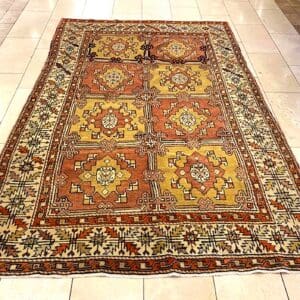 Handmade old Turkish geometric carpet in warm camel, ochre and muted terracotta with ivory border