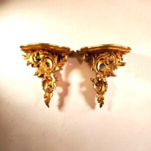 Pair of antique gilt wall shelves in Italian Rococo-style gilt gesso with scrolling acanthus decoration at The Chapman Collection